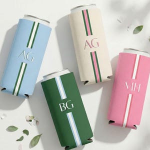 May include: Four personalised can coolers in light blue, cream, green, and pink. Each cooler features a vertical stripe design with initials and a white stripe. The initials are AG, BG, and MH.
