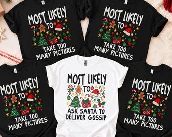 May include: Four short-sleeve t-shirts with Christmas graphics. Three black shirts feature the text "MOST LIKELY TO TAKE TOO MANY PICTURES," and one white shirt features the text "MOST LIKELY TO ASK SANTA TO DELIVER GOSSIP" with holiday icons.