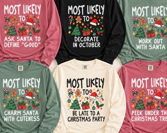 May include: Six long-sleeve crewneck sweatshirts in pink, black, sage green, and cream. Each features a graphic with a Christmas tree, gingerbread man, Santa hat, and gifts, with the text "Most Likely To" followed by unique holiday phrases.