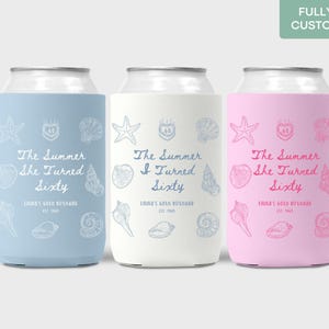 May include: Three beverage can coolers in pastel blue, white, and pink. Each cooler features a seashell and starfish design with the text "The Summer She Turned Sixty" and "Inna's 60th Birthday".
