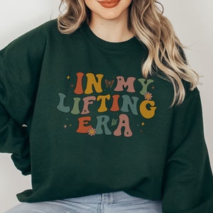 Show off your humor and strength with this In My Lifting Era sweatshirt. A great way to keep your fitness wardrobe both fun and motivational.