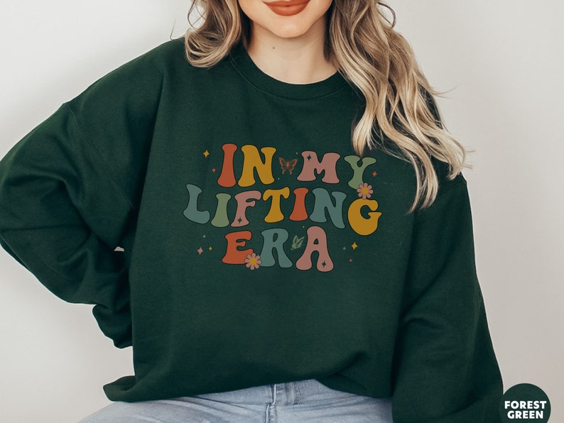 Show off your humor and strength with this In My Lifting Era sweatshirt. A great way to keep your fitness wardrobe both fun and motivational.