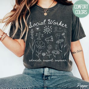 Floral social worker shirt featuring inspiring text, crafted for social work students, recent graduates, and experienced case managers making a difference.