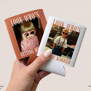 May include: Two foam can coolers, one in rust orange and one in white, each featuring a custom photograph of a child wearing sunglasses. The text "LOOK WHO'S GETTING MARRIED" is printed on both, with the white cooler also displaying the name "James".