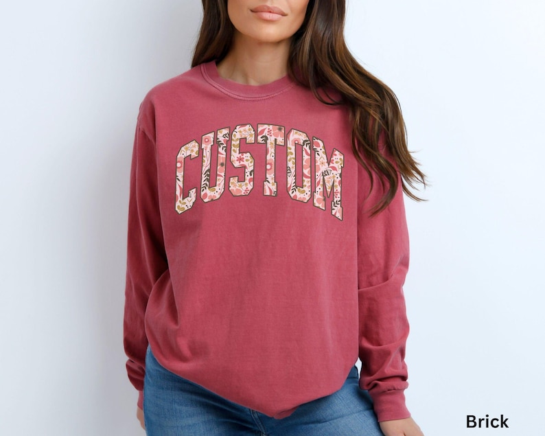 This custom long sleeve shirt features floral college-style letters, allowing you to add your own text and wear a personalized design that stands out.