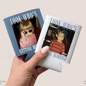 May include: Two foam can coolers, one blue and one white, each featuring a custom photograph of a child and the printed text "LOOK WHO'S GETTING MARRIED". The blue cooler has white text, while the white cooler displays blue text and a signature.