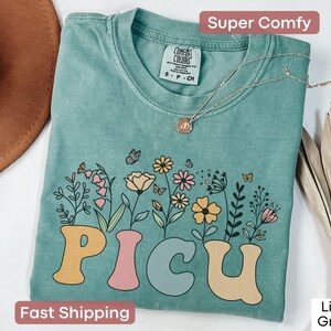 Floral PICU nurse T-shirt in Comfort Colors, a perfect gift for pediatric intensive care unit nurses or nurse appreciation events.