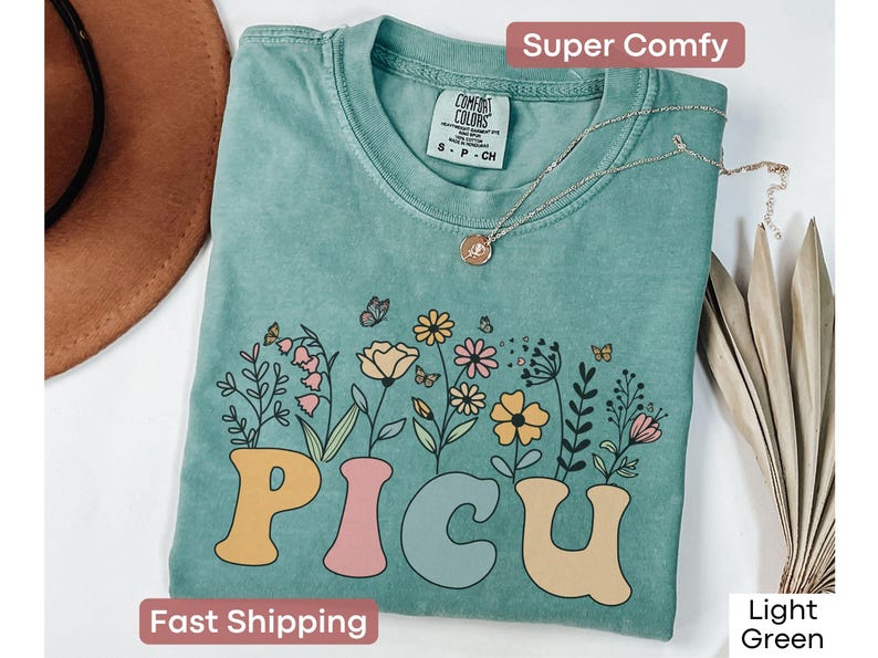 Floral PICU nurse T-shirt in Comfort Colors, a perfect gift for pediatric intensive care unit nurses or nurse appreciation events.