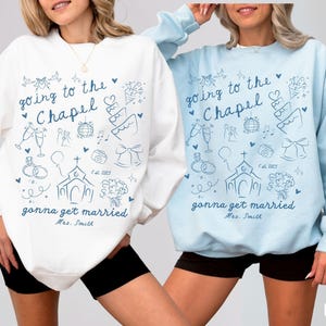 Make your bridal moments special with this personalized bride-to-be sweatshirt, ideal for bachelorette parties, honeymoon apparel, and engagement celebrations.