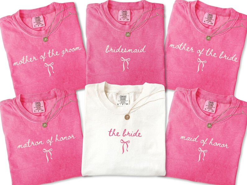 Matching Comfort Colors bridal party tees folded together with script lettering and bow detail. Ideal for bachelorette weekends and bridal party proposal gifts.