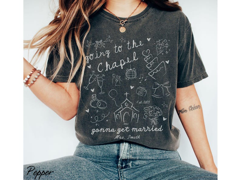 A must-have for any engaged bride, this customized Going to the Chapel Comfort Colors shirt is a stylish and sentimental keepsake for wedding festivities.