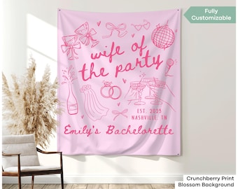 May include: Pink tapestry with the text "wife of the party" and bachelorette party-themed illustrations. Includes the text "Emily's Bachelorette" and "EST. 2025 Nashville, TN".