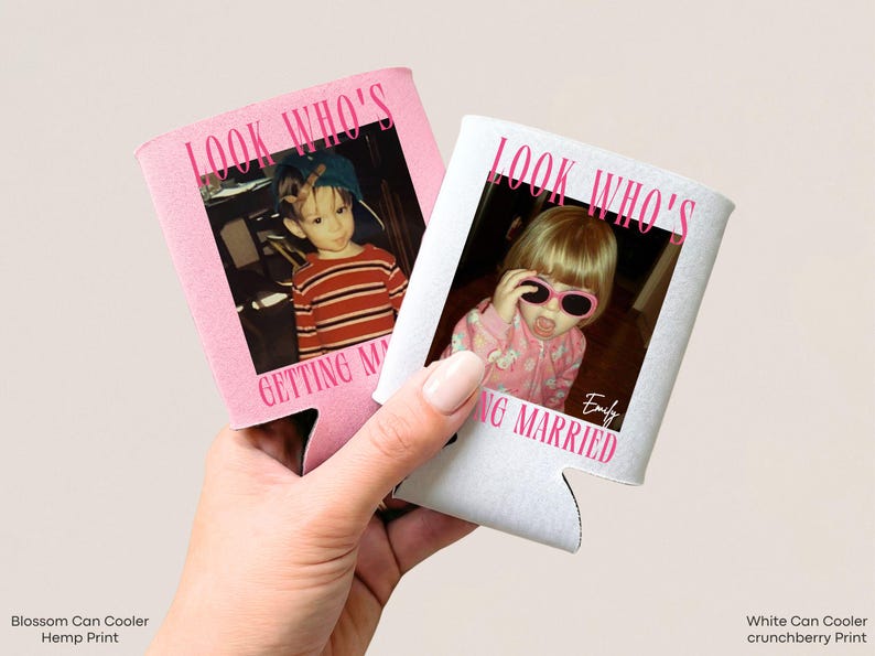 May include: Two foam can coolers, one light pink and one white, each featuring a childhood photograph and the printed text "LOOK WHO'S GETTING MARRIED" in bold pink lettering. The white cooler also includes the name "Emily" in a script font.