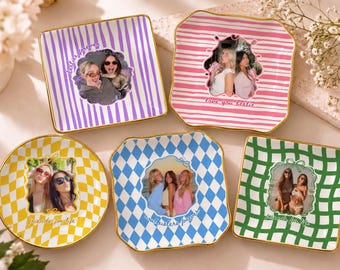 May include: Five square and round ceramic trinket dishes with gold-painted rims. Each dish features a unique pattern including purple stripes, pink stripes, yellow checkers, blue diamonds, and green checkers, with custom photo prints and text.