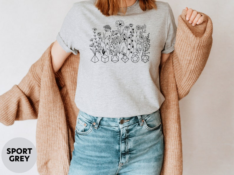 Unique DnD shirt featuring flowers and dice, great for women who enjoy tabletop role-playing games.