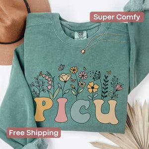 Comfort Colors floral PICU nurse sweatshirt, a cozy and stylish gift for pediatric ICU nurses or Nurse Week recognition.