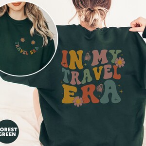 Trendy sweatshirt with an eye-catching In My Travel Era design. Ideal for travel bloggers or influencers who love to showcase their journeys in style.