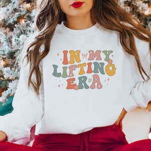Wear your strength with pride with this In My Lifting Era sweatshirt. Ideal for anyone who is dedicated to their fitness journey and loves motivational gear.