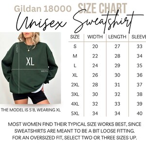 May include: Size chart for a unisex Gildan 18000 sweatshirt. The chart shows measurements in inches for width, length, and sleeve length for sizes S through 5XL. The model is wearing a size XL.