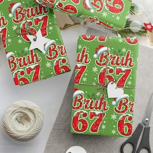 May include: Green Christmas wrapping paper featuring the text "Bruh 67" in red and white, decorated with Santa hats and snowflakes. The wrapped gifts are tied with twine and decorated with star and heart-shaped tags.