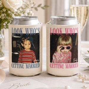 May include: Two off-white foam can coolers featuring custom photo prints. The left cooler displays a child in a striped shirt with the text "LOOK WHO'S GETTING MARRIED" in blue and the name "James". The right cooler shows a child in pink with the same text in pink and the name "Emily".