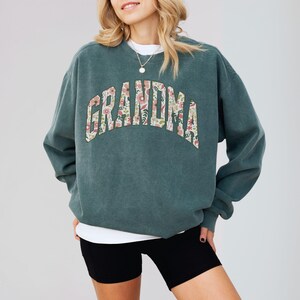 This cozy floral Grandma shirt celebrates the special role of grandmothers with beautiful floral designs. A perfect gift for any grandma to wear proudly. Great for a christmas present.