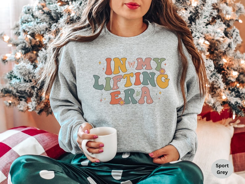 Trendy sweatshirt with a retro In My Lifting Era design. Perfect for women who love lifting weights and showcasing their strength in style.