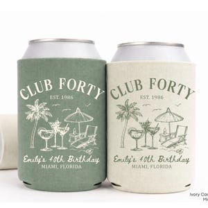 Two cans with a beach theme, featuring palm trees, umbrellas, and a glass of wine.