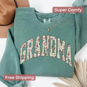 This cozy floral Grandma shirt celebrates the special role of grandmothers with beautiful floral designs. A perfect gift for any grandma to wear proudly. Great for a christmas present.