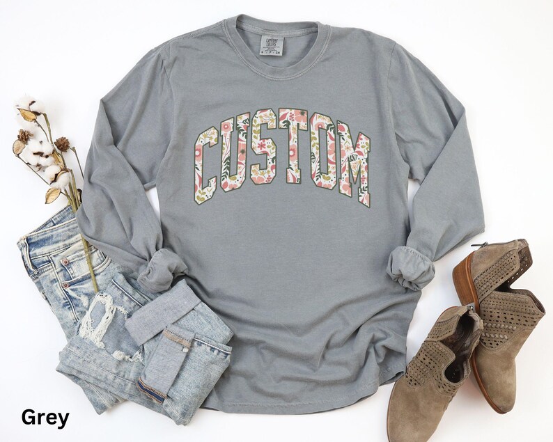 Create a one-of-a-kind look with this custom long sleeve t-shirt, where you can add your own text to the floral design for a truly unique style.