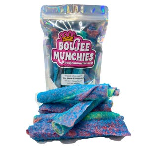 May include: A clear bag of freeze-dried candy rolls with the text "Boujee Munchies" and "Blue Raspberry Fruit Rollups". The candy rolls are blue, red, and green, and are covered in a sugary coating. The bag is on a white background.