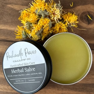 May include: A small tin of herbal salve with a black label that reads "Panhandle Prairie Tallow Co. Handcrafted Skin Care Herbal Salve For cuts, scrapes, bug bites, rashes, and itchy skin. Net Wt. 2 oz Lavender".