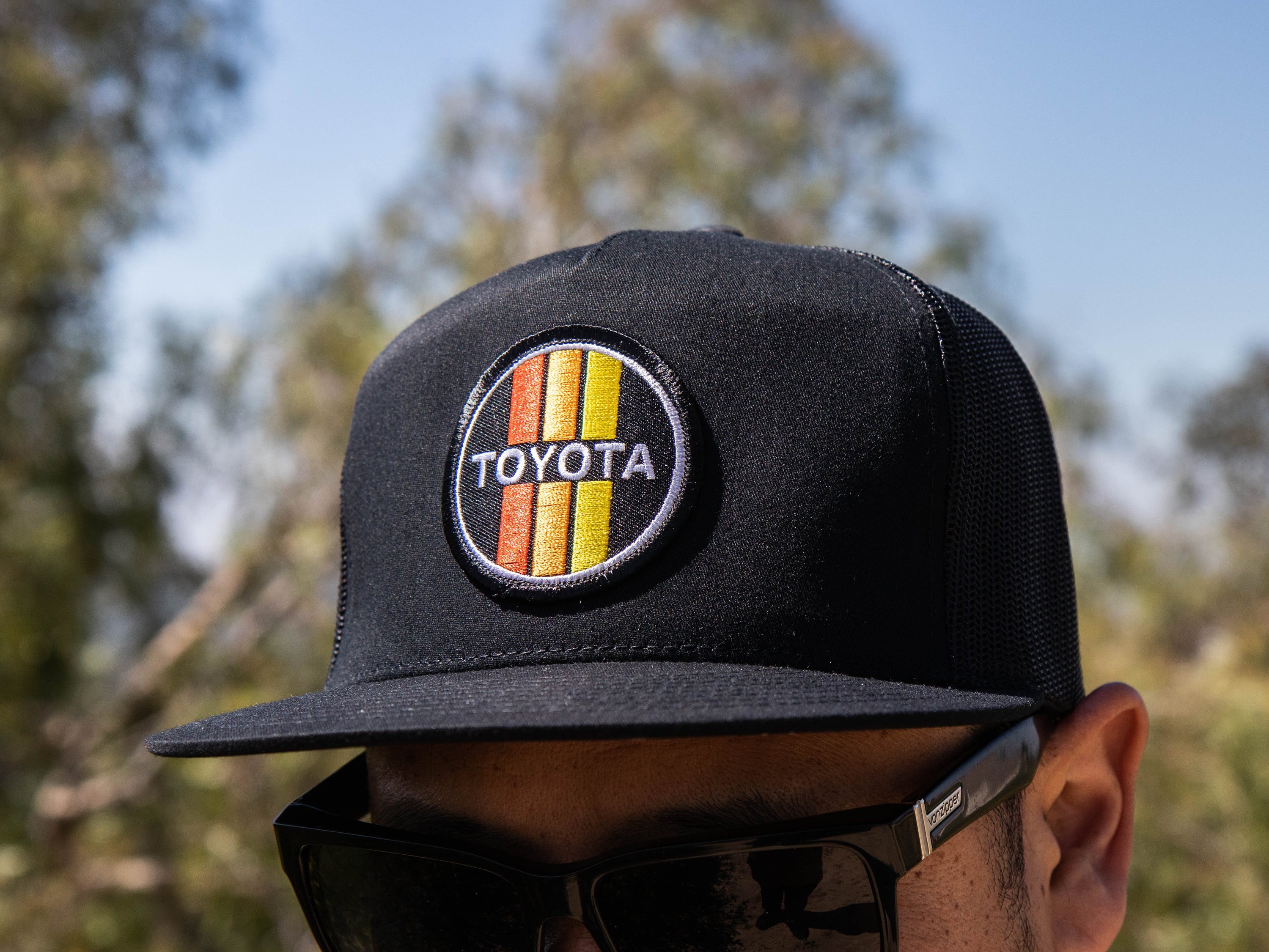 TOYOTA Circle Retro Racing Stripes Black Snapback Trucker Hat With  topographic Design Under Flat Brim 