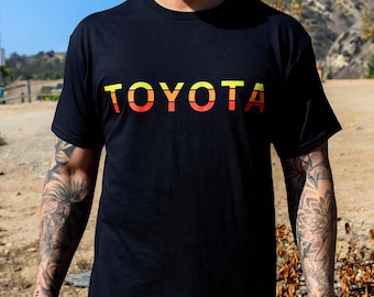 Camisetas negras con el logotipo de TOYOTA y el esquema de colores de carreras