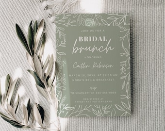 May include: A green invitation card with white floral illustrations and the text "Join us for a Bridal Brunch honoring Caitlin Robinson March 18, 20XX at 11:00 AM Nora's Bed & Breakfast RSVP to Scarlett at 555-555-0055 Registered at Target and Pottery Barn".