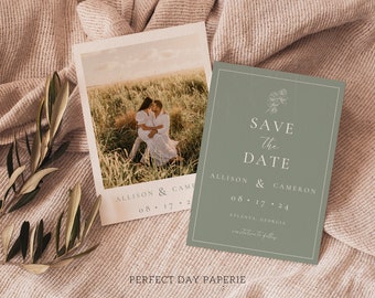 May include: A green save the date card with white text. The card says "Save the Date" with a floral design at the top. The text below reads "Allison & Cameron" and "08.17.24" with the location "Atlanta, Georgia".