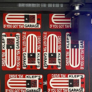 May include: Six red, white and blue keychains with the text "Drive 'em Klep's If you got 'em Garage" and a YouTube logo.