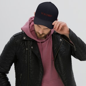 May include: A black baseball cap with the text "YOU DIED" embroidered in red on the front.
