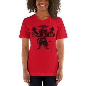 May include: Red short-sleeved t-shirt with a black graphic of a demon with the text "YOU DIED" in red.