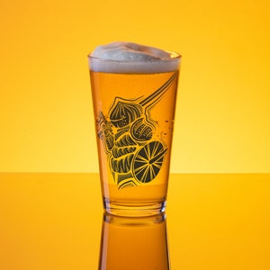 May include: A pint glass filled with beer and a foamy head. The glass has a black illustration of a knight with a sword and shield. The background is a gradient of yellow.