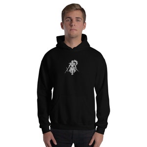 May include: Black hoodie featuring a white illustration of a warrior holding two swords. The graphic is positioned centrally. The sweatshirt includes a front pocket and a drawstring hood.