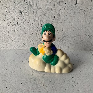 1989 Luigi wheel wind kinetic toy. Pull back. Spin drive. Nintendo of America. McDonald’s toy. Video game character. Cloud Racer. 80’s toys.