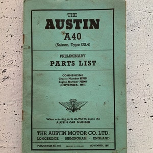 May include: A green booklet titled "The Austin A40 (Saloon, Type GS.4) Preliminary Parts List" with the Austin Motor Company logo and the text "Commencing Chassis Number 857001 Engine Number 700001 (November, 1951)" and "When ordering parts ALWAYS quote the AUSTIN CAR NUMBER".