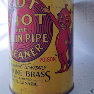 May include: Yellow metal can with a red and black illustration of a devil character. The can reads "Hot Shot The Drain Pipe Cleaner" and "Poison". The text also reads "Plumbing Sanitary" and "Marine Brass Company, Limited, Toronto, Canada."