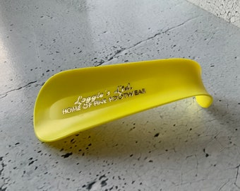 Loggies Footwear Shoehorn. Vintage collectible shoehorns. Footwear and apparel. Promo Department store ad item. Plastic shoehorn. 106 years.