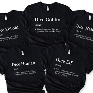 May include: Black t-shirts with white text featuring definitions for "Dice Kobold," "Dice Goblin," "Dice Halfling," "Dice Human," and "Dice Elf." Each shirt has a unique definition related to dice.
