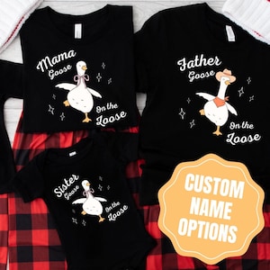 May include: Black family matching shirts with goose graphics. The shirts read "Mama Goose", "Father Goose", and "Sister Goose" with the text "On the Loose". A yellow sign says "Custom Name Options".
