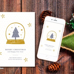 May include: A Christmas card and a smartphone displaying a similar design. The card and phone screen feature a snow globe illustration with a gray tree and gold accents, along with the text "Merry Christmas and Happy New Year."