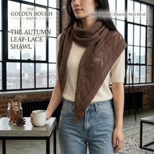 May include: A brown triangular shawl featuring an intricate leaf-lace pattern and a small leather-look tag. The text on the image reads: THE GOLDEN BOUGH KNITS, THE AUTUMN LEAF-LACE SHAWL, Hand-Knitted | Premium Wool Blend.