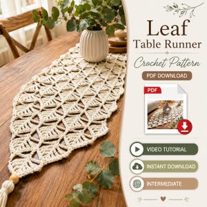 May include: A cream-colored crochet table runner featuring a repeating leaf pattern with a tassel at the end. The text reads Leaf Table Runner Crochet Pattern, PDF DOWNLOAD, VIDEO TUTORIAL, INSTANT DOWNLOAD, and INTERMEDIATE.